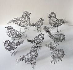 six wire birds sitting on top of each other