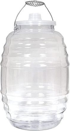 a large clear glass jar with a metal handle on the top and bottom, hanging from a wire