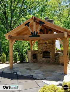 a gazebo with an outdoor fireplace in the middle