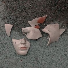 three pieces of clay with faces cut out on the ground