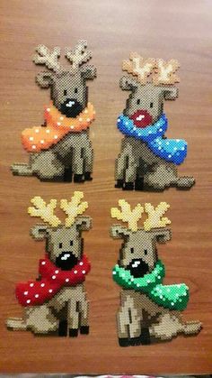 four different types of reindeers are shown on a wooden surface with beads and sequins