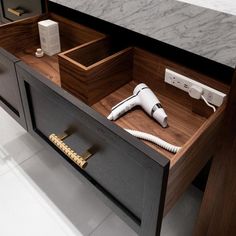 a hair dryer sitting on top of a wooden drawer