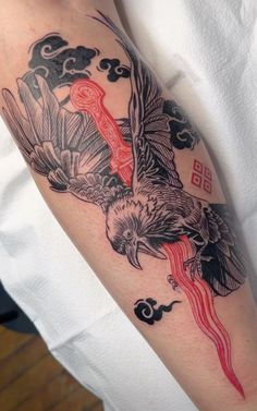 a person with a bird tattoo on their arm