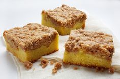 three pieces of cake sitting on top of a white cloth