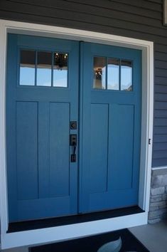 a blue front door with two windows