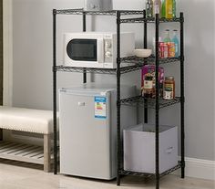 a kitchen shelving unit with a microwave and refrigerator