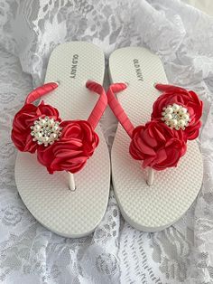 These beautiful flip flops is wrapped with coral satin ribbon, and adorned with a coral/peach chiffon flower and adorned with a Rhinestones and pearls center piece.  Ribbon color is coral , if you are needing other colors of ribbon or decoration please contact me and will be happy to accommodate you!   Flip flops can be made in adult size also. All flip flops are handmade to order and the production time is 1 to 2 weeks business days and then please allow time for shipping. Amazing for beach, we Adjustable Pink Sandals For Wedding, Elegant Pink Summer Flip Flops, Flower Shaped Flip Flops For Beach, Beach Wedding Flip Flops, Flip Flop Art, Pink Non-slip Spring Flip Flops, Red Slip-on Flip Flops For The Beach, Custom Flip Flops, Coral Wedding Flowers