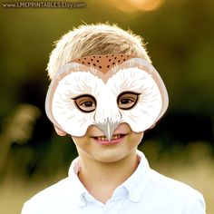 a young boy with an owl mask on his face