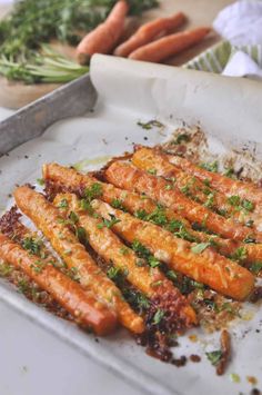 carrots and parmesan roasted carrots on a baking sheet with seasoning