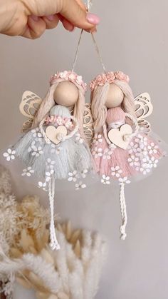 two little fairy dolls hanging from strings