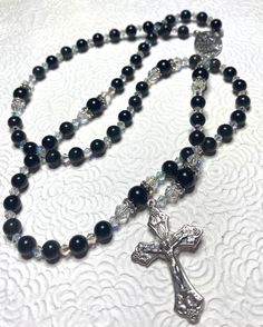 Beaded black obsidian rosary with swarvoski pearls as decade beads and Italian crucifix and connector. Supervise around small children as beads are a choking hazard. Adjustable Black Rosary With Cross, Adjustable Black Cross Rosary, Black Beaded Cross-shaped Rosary, Black Beaded Cross Rosary, Black Spiritual Rosary Bracelet With Cross, Handmade Black Cross Rosary Bracelet, Black Crucifix Rosary Bracelet As Gift, Black Crucifix Rosary As Gift, Pumpkin Tree