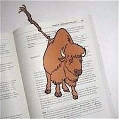 an open book with a drawing of a bison on it