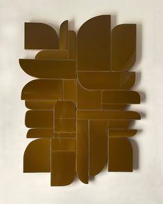 a piece of art that is made out of brown paper and has been cut into smaller shapes