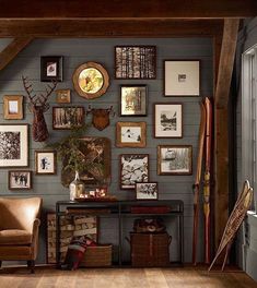 a living room filled with furniture and pictures on the wall next to a chair in front of a table