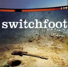 a sign that says switchfoot in front of a broken water hole with a wrench laying on the ground