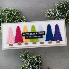 there is a card with different colored trees on it and the words faith, hope & peace to you and yours