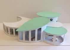 a paper model of a house with two windows and a roof that looks like a bird's nest