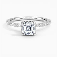 an emerald cut diamond engagement ring with pave set shoulders