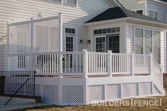 a white house with a porch and fence