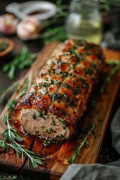 the meat is covered with herbs and ready to be cooked in the oven on the cutting board