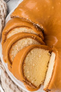 a bundt cake with slices cut out and sitting on top of a white plate