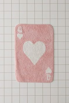 a pink rug with white hearts on it