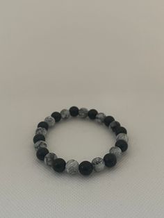 This bracelet is made with 8mm grey marble and black obsidian beads. This bracelet is around 17cm and made with elastic. Grey Beaded Bracelet, Casual Black Beaded Bracelets With Natural Stones, Casual Gray Beaded Bracelets, Casual Black Bracelets With Natural Stones, Casual Gray Bracelet With Round Beads, Casual Gray Bracelet, Casual Black Stretch Bracelet, Casual Black Stretch Bracelet With 8mm Beads, Casual Black Round Stretch Bracelet