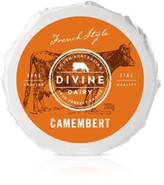 an orange and white cheese label with a cow on it's side, in front of a white background