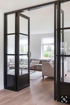 an open glass door leading to a living room