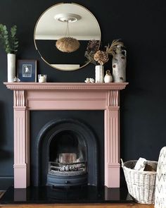 a living room with a fireplace and mirror