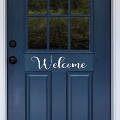 a blue door with the words welcome painted on it