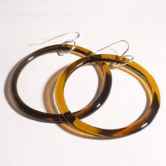 two pairs of hoop earrings sitting on top of each other