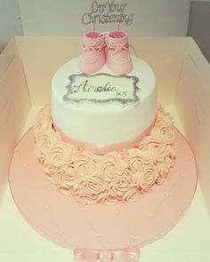 there is a cake in the box with pink shoes on top