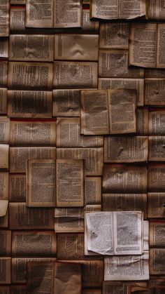 many books are stacked on top of each other and one has a piece of paper pinned to it