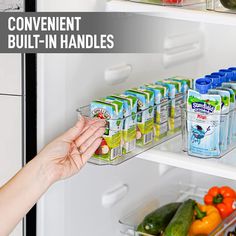 a person reaching into an open refrigerator to grab some food from the shelves with their hands