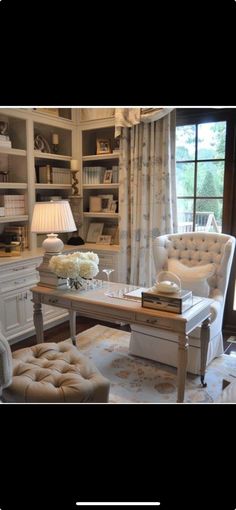 a living room filled with lots of furniture and bookshelves next to a window