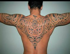 the back of a man with tattoos on his body