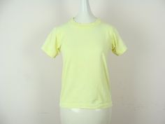 "Bright and fun vintage kid's neon yellow t-shirt from the late 80s / early 90s. Classic tee style with single stitching. Seems to have been dyed yellow, as it's a bit brighter in some places than others and has some fading and dye inconsistencies, which I feel only adds to the coolness and uniqueness of a vintage piece such as this. Label: \"Screen Stars Best\". Made in U.S.A. Fiber content: 50% cotton, 50% polyester. Stamped size: 14-16. Please see measurements to ensure a proper fit. Though i Denim Jumper Dress, Vintage Jumpsuit, Late 80s, Yellow T Shirt, Early 90s, Yellow Top, Overall Dress, Kids Tops, Neon Yellow