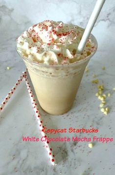 white chocolate mocha frappe with sprinkles and candy cane on the side