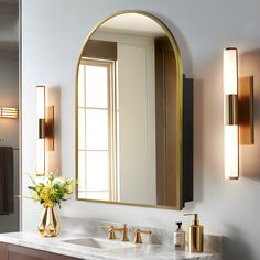 a bathroom vanity with two sinks and a large mirror over the sink in front of it