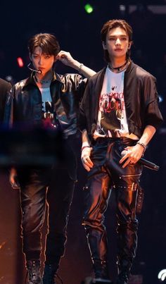 two young men standing next to each other on stage