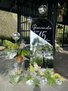 the entrance to benvendi's in miami is decorated with flowers and greenery