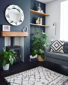 a living room filled with furniture and a mirror on the wall next to a fire place