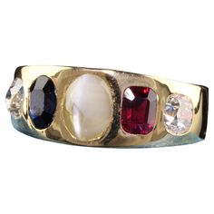 Beautiful Antique Victorian 18K Yellow Gold Old Mine Diamond Ruby Sapphire Flush Set Ring. This incredible ring is crafted in 18k yellow gold. The ring has two chunky old mine cut diamonds on the sides with a natural ruby and sapphire and a cats eye chrysoberyl in the center. It is truly an amazing ring and in great condition. Item #R1358 Metal: 18K Yellow Gold Weight: 7.9 Grams Size: 8 Diamond: Approximately 1 cts Color: H Clarity: SI1 Sapphire: Approximately 1 ct Ruby: Approximately 1 ct Chrys Ruby And Sapphire, Vintage Gold Earrings, Cabochon Ring, Ruby Sapphire, Cats Eye, Set Ring, Antique Engagement Rings, Antique Diamond, Natural Ruby