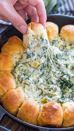 spinach dip in a cast iron skillet with bread