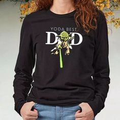 a woman wearing a yoda best dad shirt