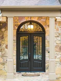 the front entrance to a home with double doors