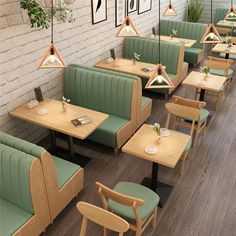 an empty restaurant with green booths and wooden tables