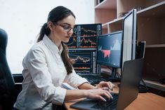 a woman working on her computer in an office