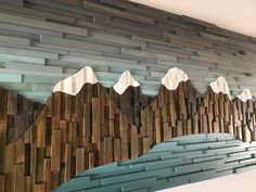 a wooden wall with mountains painted on it